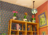 The second lamp in the corner over the cabinet.