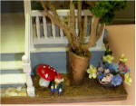 Close-up of the right side of front steps. Notice the gnome sitting under the mushroom.