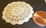 One of three one inch lace doilies