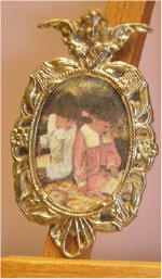 Brother & Sister reading in Gold Oval w/Cherub Frame